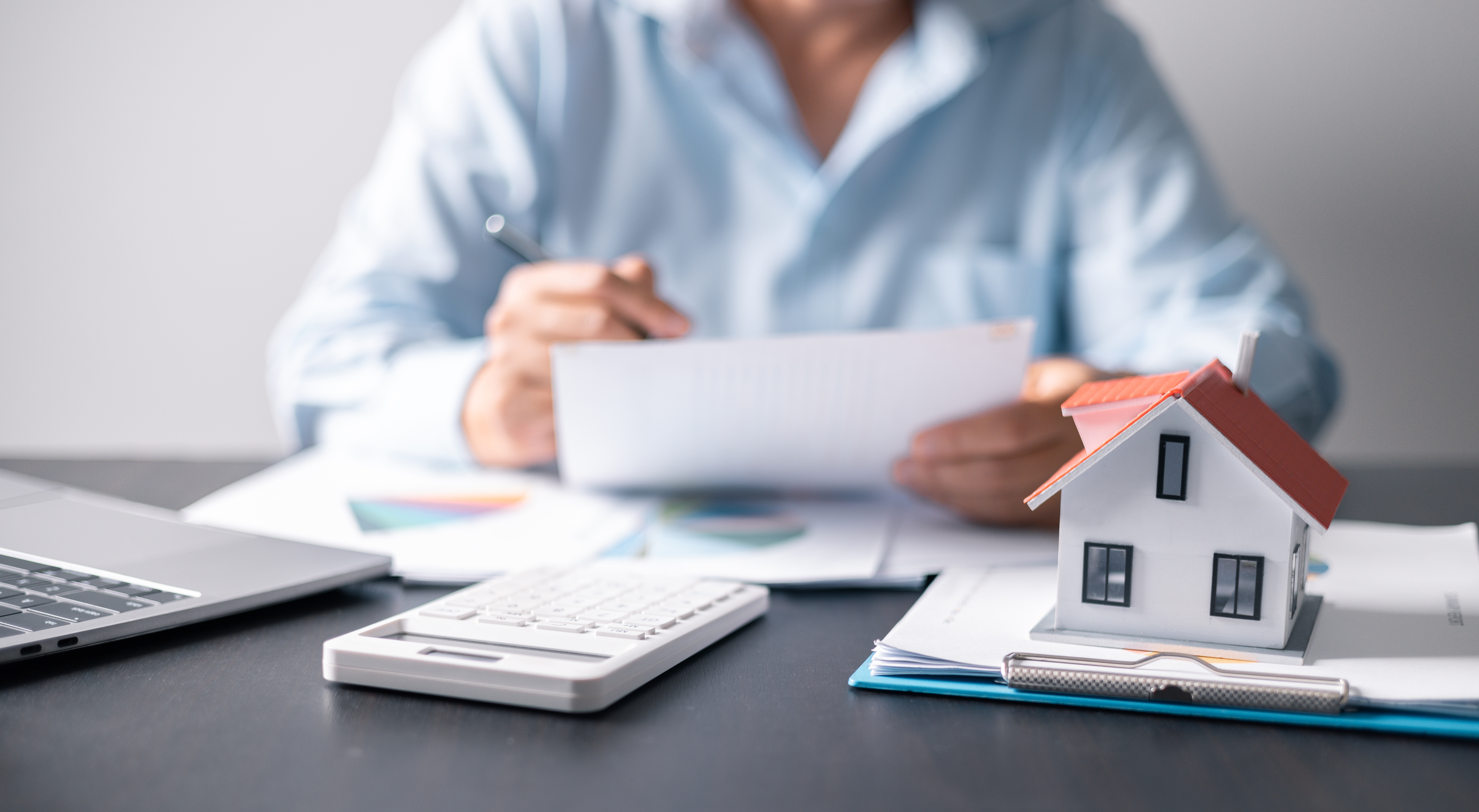 Property manager at a desk with paperwork.